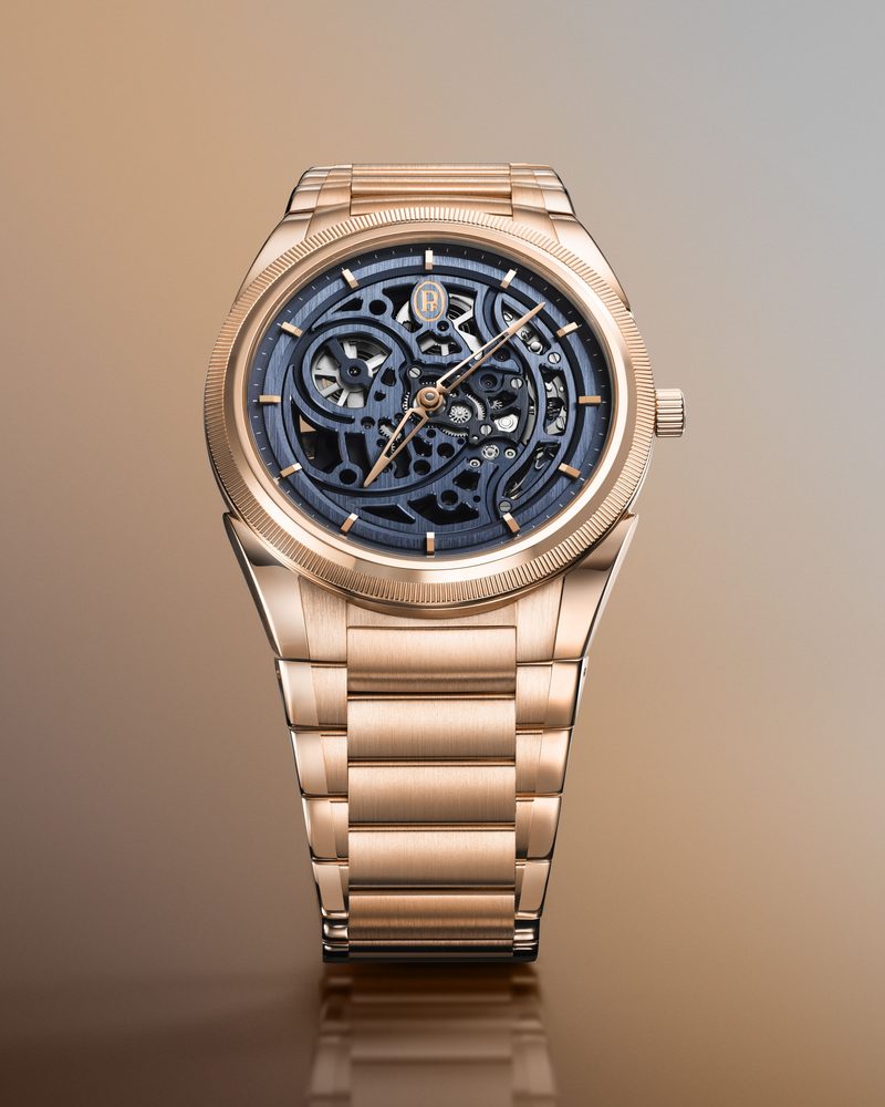 Rose gold watch with a blue skeleton dial and bracelet